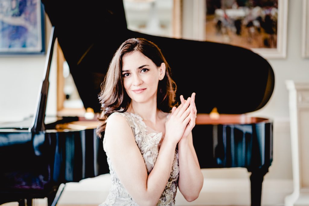 Andrej Grilc, a woman with dark hair sitting in front of a grand piano